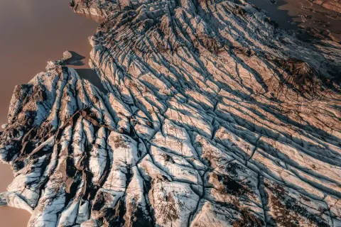Aerial view of the crevassed snout of Sólheimajökull glacier in low sun